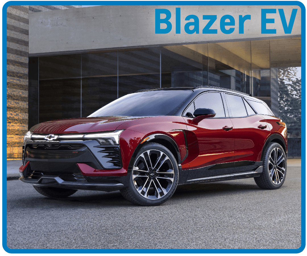 Red Chevrolet Blazer EV parked in front of a modern building showcases sleek electric SUV design.