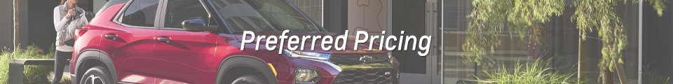 Red SUV parked near greenery with "Preferred Pricing" text overlay. Ideal for car deals and promotions.