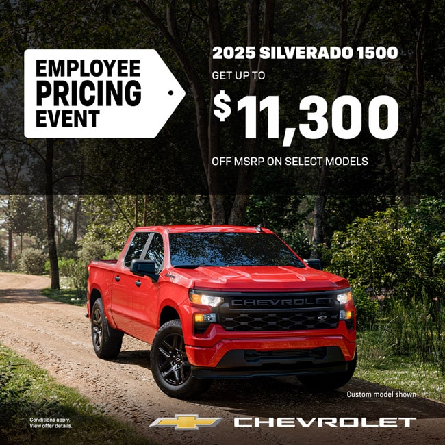 Red 2025 Chevrolet Silverado 1500 on forest road. Employee pricing offers up to $11,300 off MSRP.