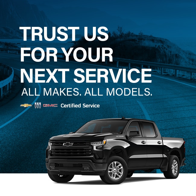 Black Chevrolet truck on road with "Trust Us for Your Next Service" text promoting certified services for all vehicle makes and models.