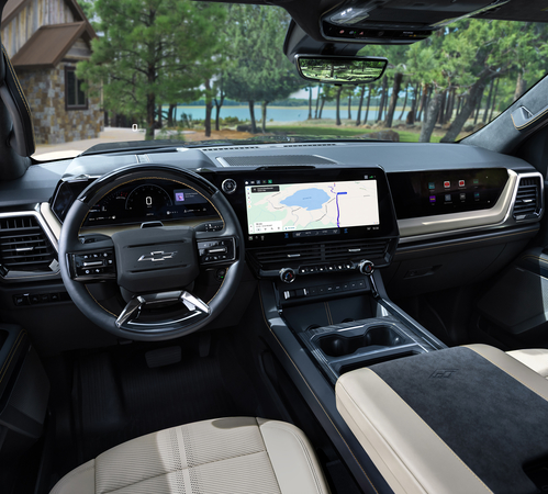 Modern SUV interior with touchscreen navigation, digital dashboard, and sleek design overlooking a forest lake.