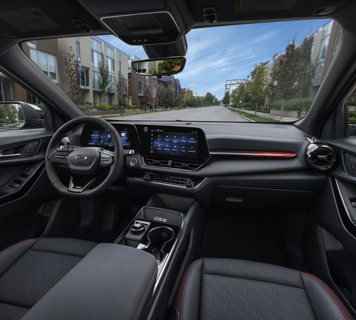 Modern car interior showcasing a sleek dashboard with digital display, steering wheel, and street view.