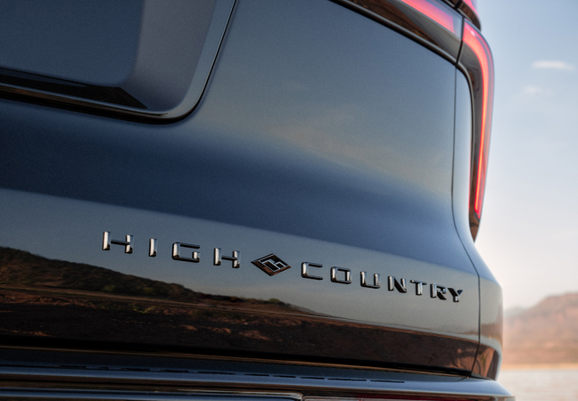 Close-up of a vehicle's rear with "High Country" emblem and partial taillight.